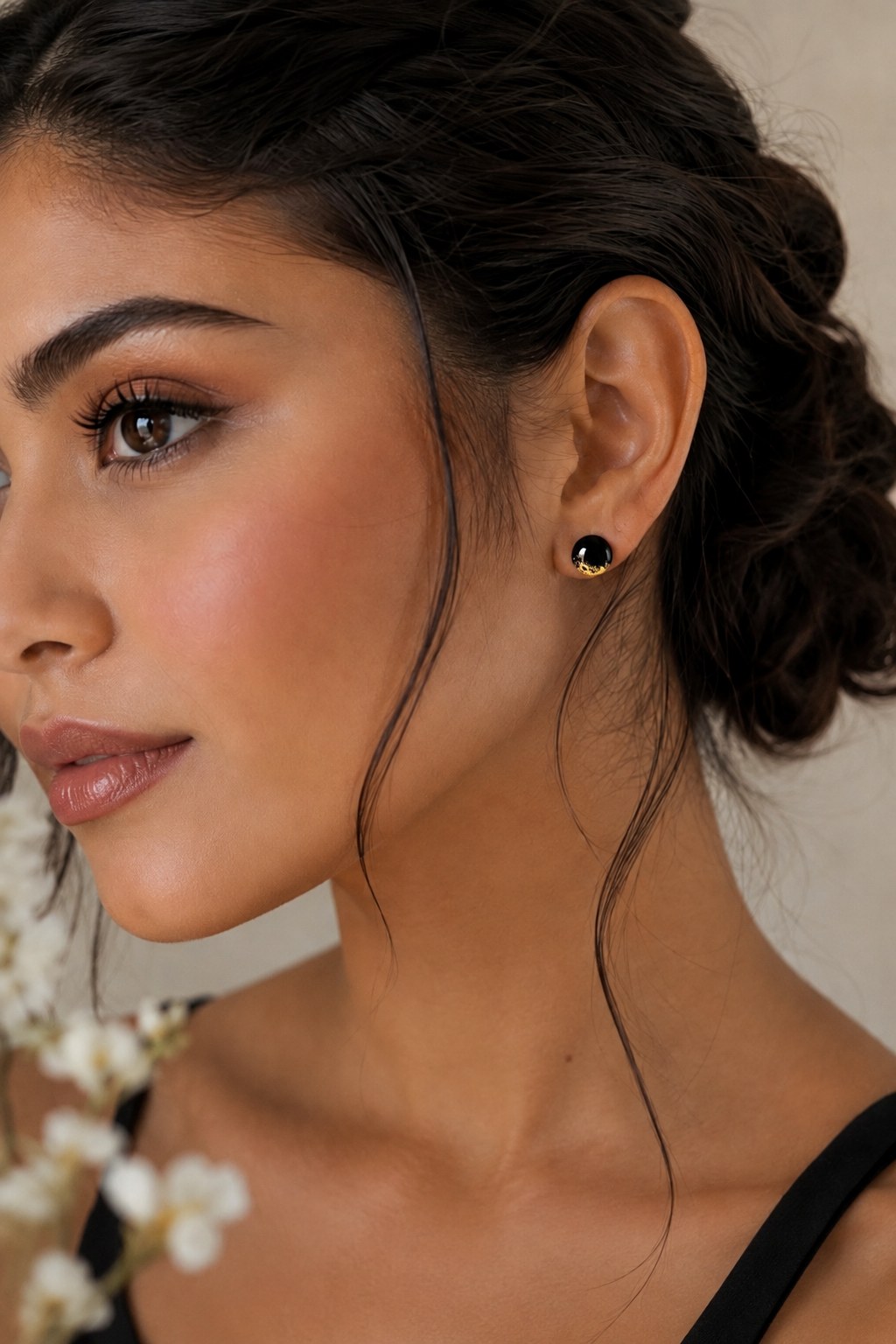 Black and gold memorial stud earrings worn on a model