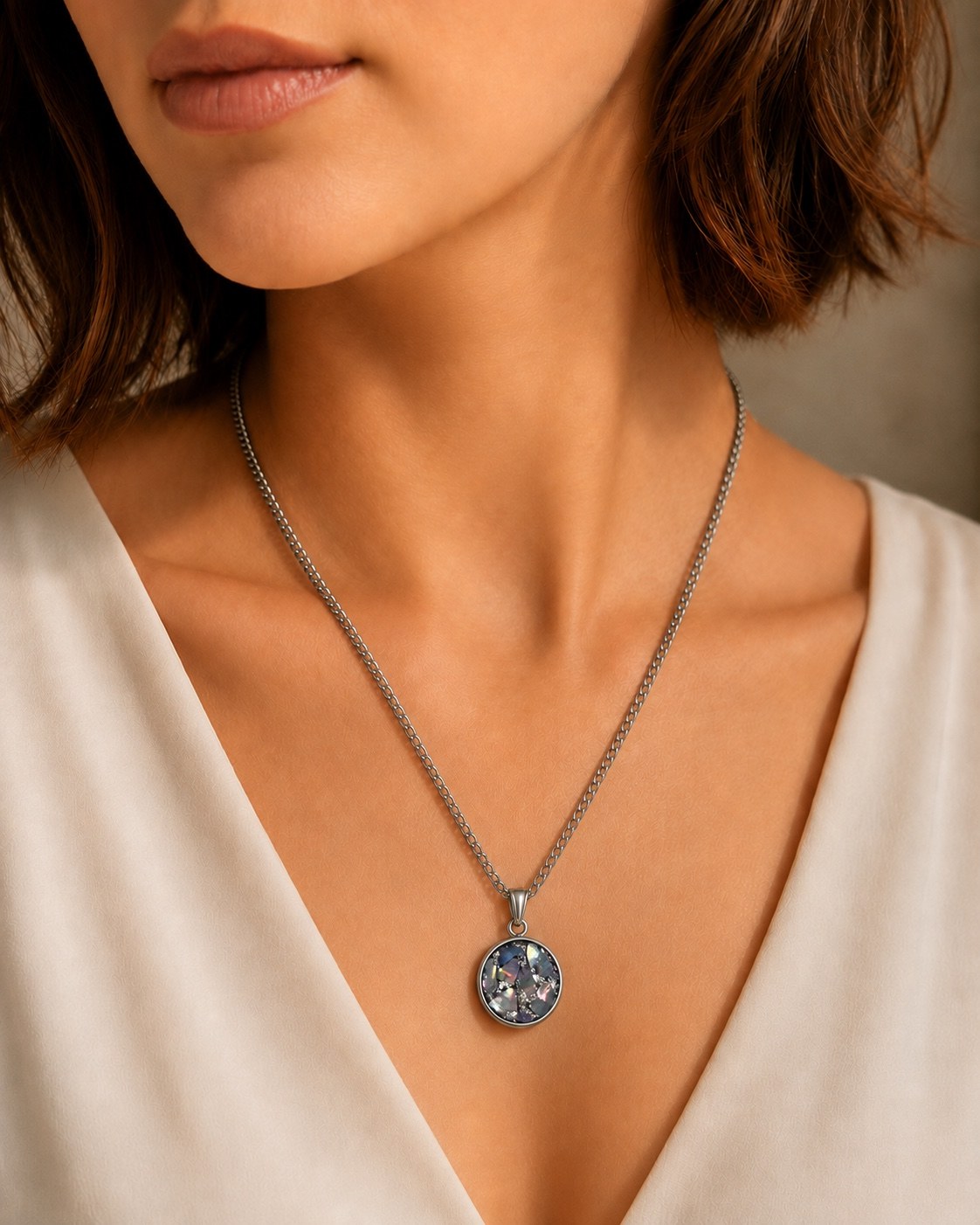 Silver mosaic oval memorial pendant worn on a model