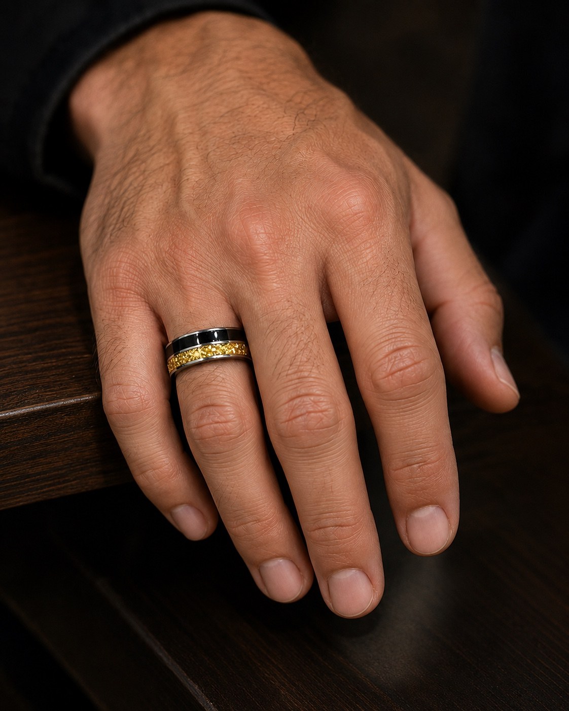 Black and gold double channel memorial ring worn on a male hand