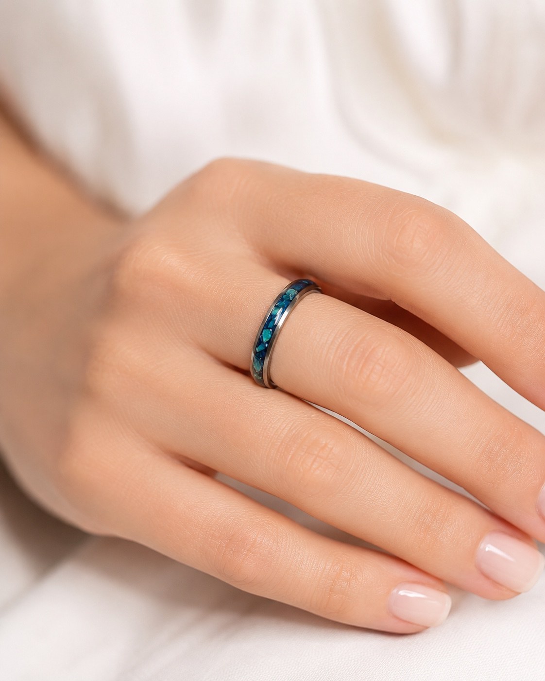 Blue inlay memorial ring worn on a hand