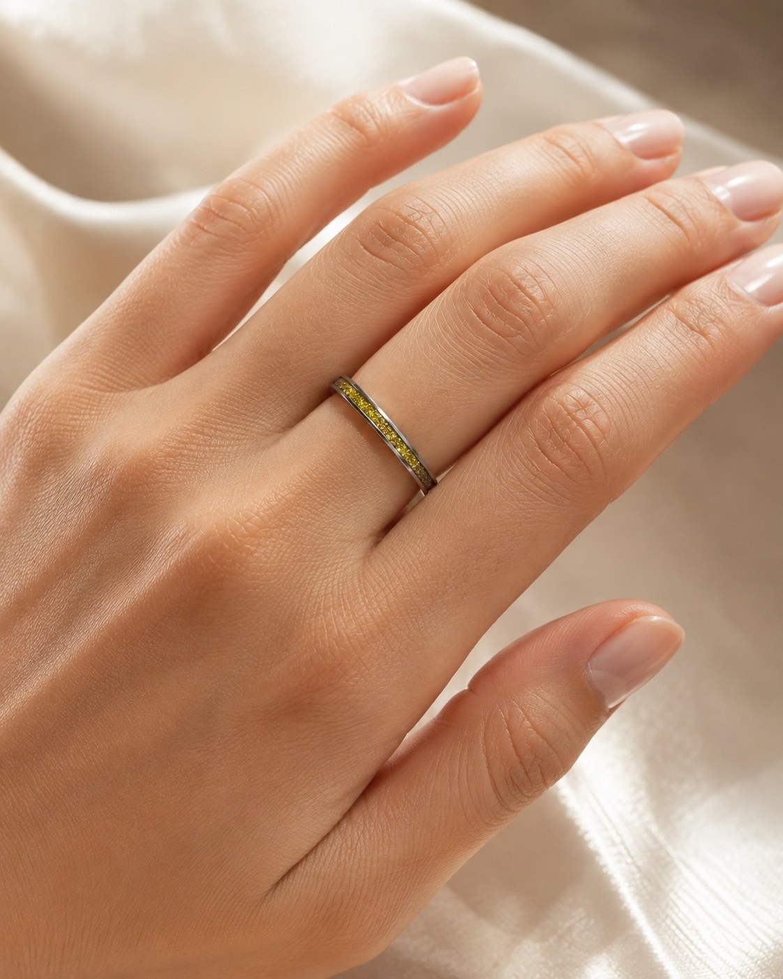 Gold sparkle memorial ring worn on a hand