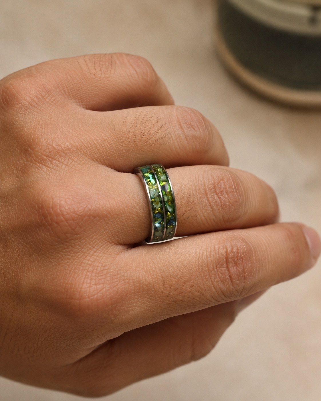 Green double channel memorial ring worn on a male hand