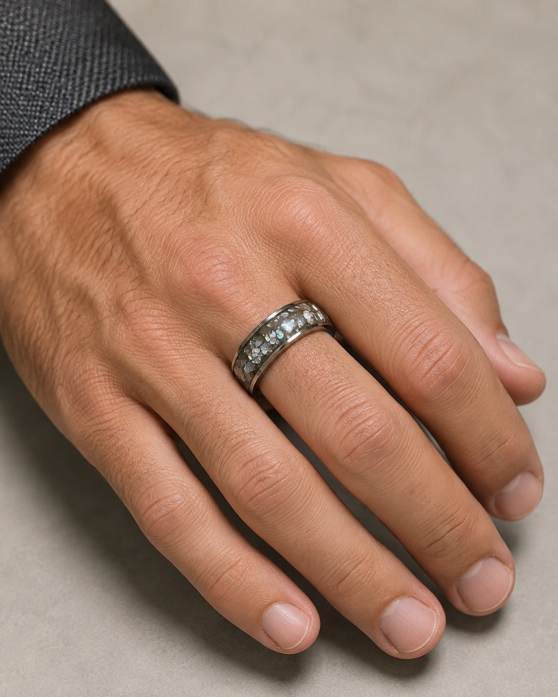 Silver chip wide memorial ring worn on a male hand
