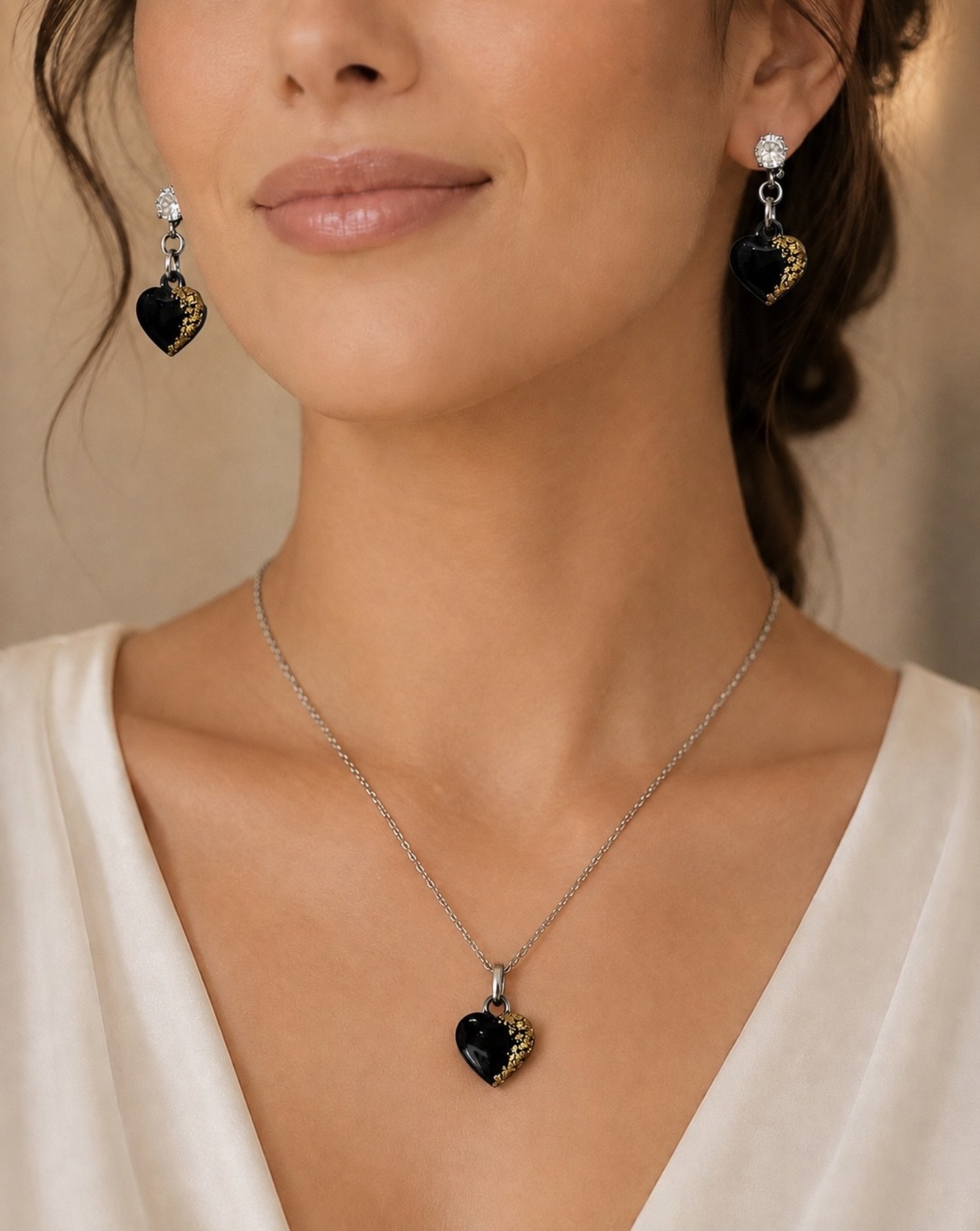 Black and gold heart memorial jewellery set worn on a model