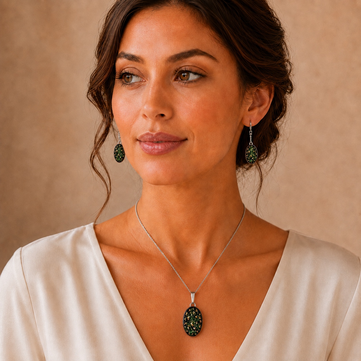 Black, emerald green and gold oval memorial jewellery set worn on a model