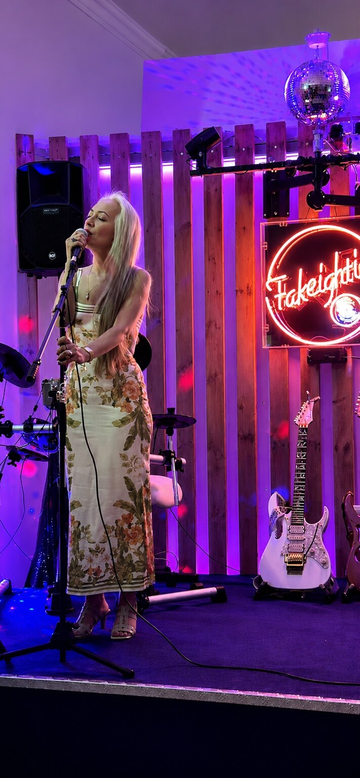 Renée performing on stage under purple lights
